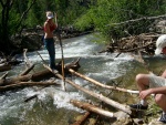 Crossing the river on our makeshift "bridge".