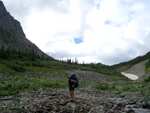 Mayela crossing a cool little stream, as we approach the tree line.