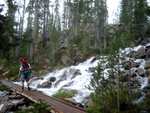 Paul crossing a waterfall just below Imogene Lake.