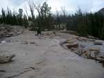 Heading back across the (wet) rock slabs toward Imogene Lake.
