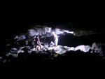 Mayela & Brandon in a larger cave with a few openings, including this "skylight".