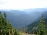 Amazing view looking West into Idaho and Montana.  Priest River and Upper Priest Lake can be seen in the background.  Mayela is climbing about 80 feet from the camera, showing just how steep the climb up Snowy Top was.
