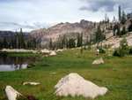 Mayela crossing an alpine meadow, just above the Imogene Lake basin.